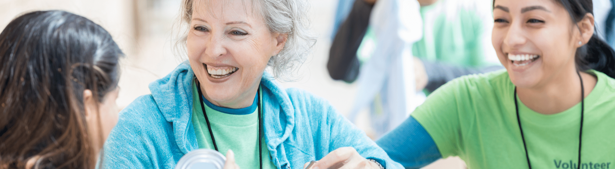 Three smiling people volunteering