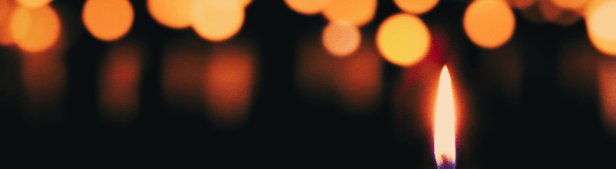 Group of lit candles on dark background